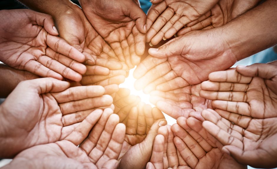 Hands joined together in support of community outreach